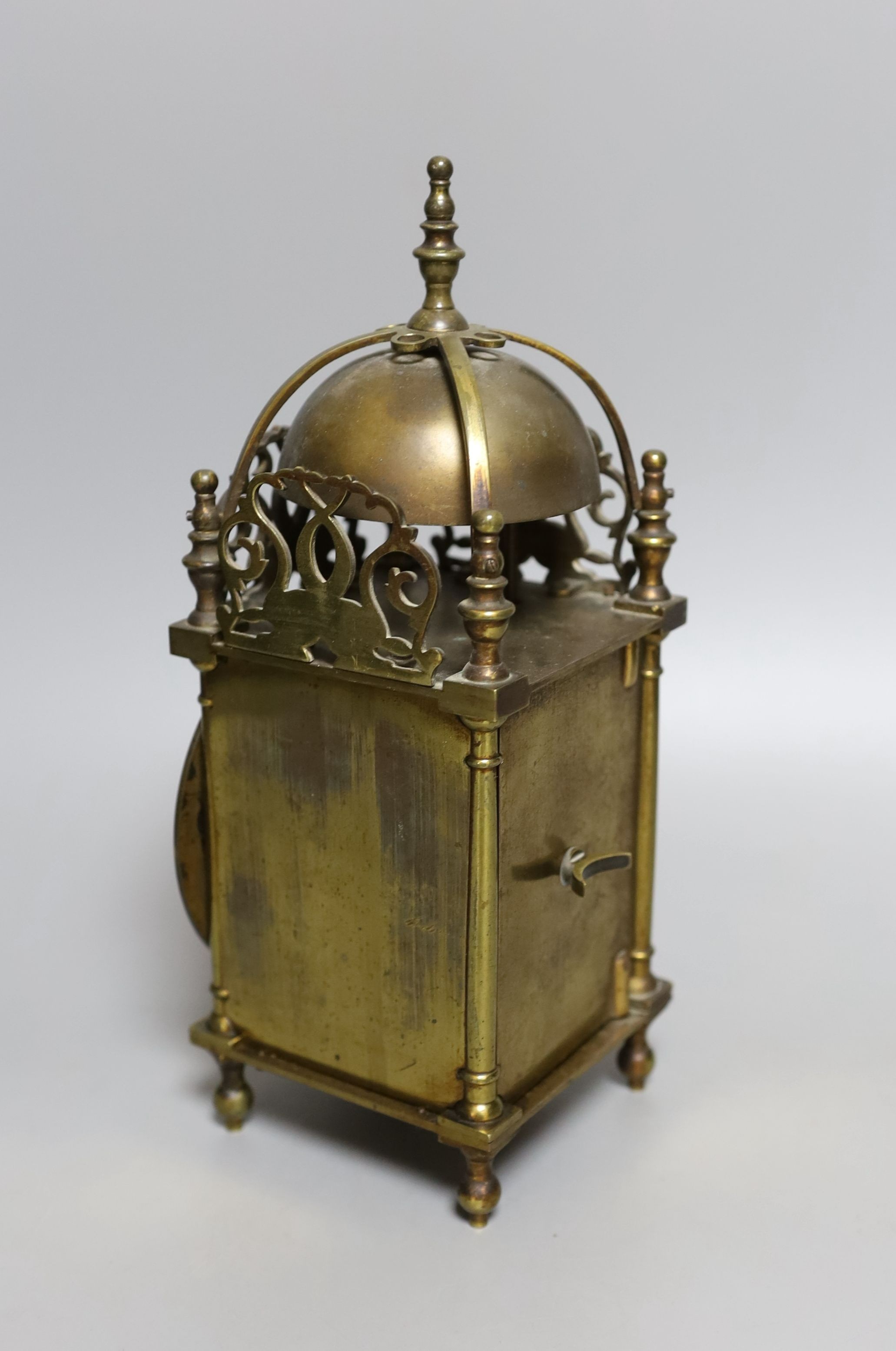 A 19th century miniature brass lantern clock, with key. 24cm